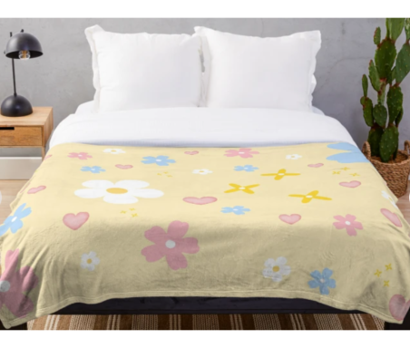 a happy floral throw blanket on a bed